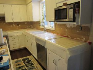 before image of kitchen with plaster