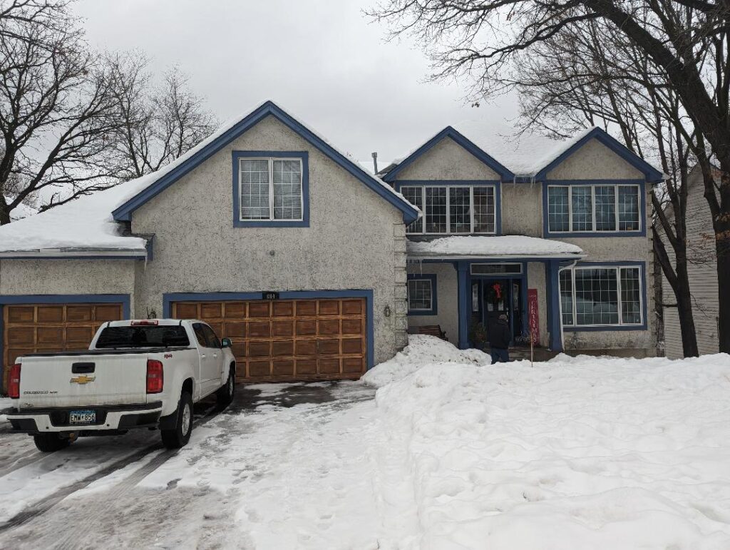 Before image of a stucco repair project on a house