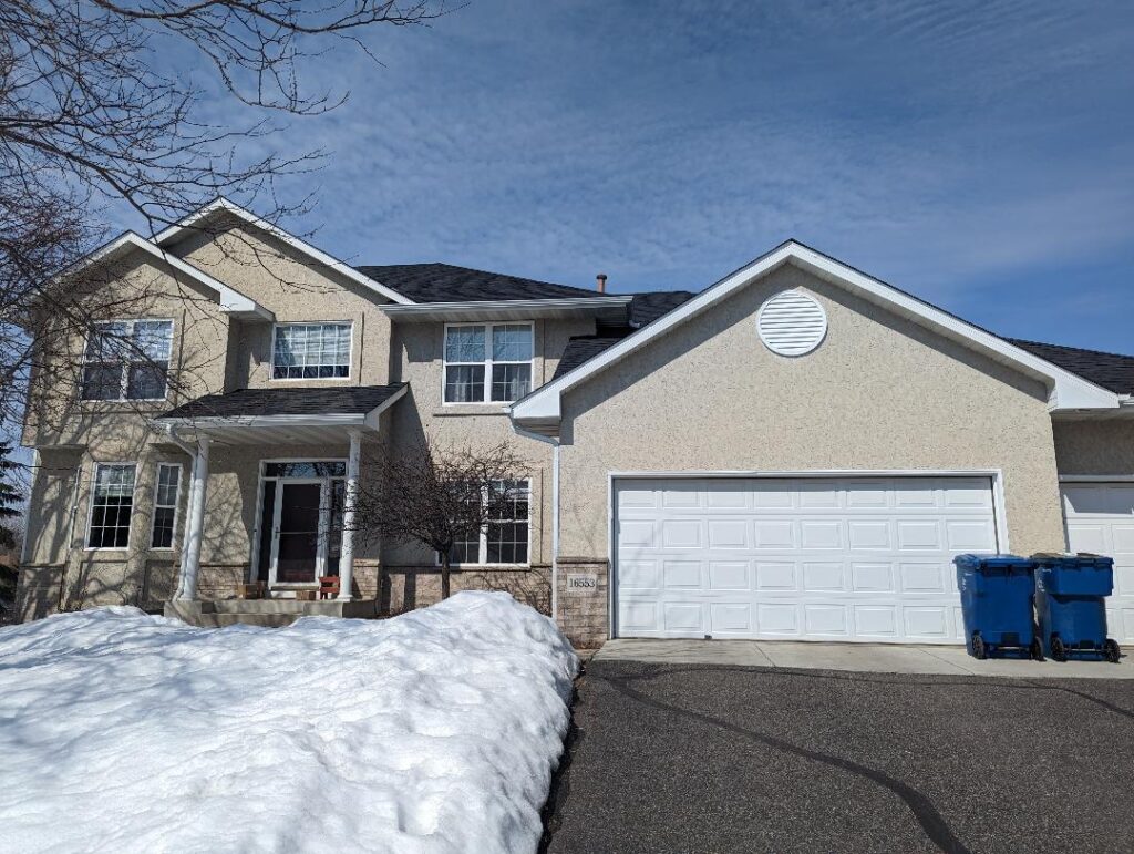 Before image of a stucco repair project on a house