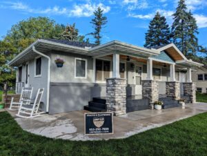 After picture of a house in need of stucco patching and painting