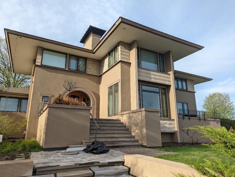 Sharp two-story house after having its stucco sealed and painted