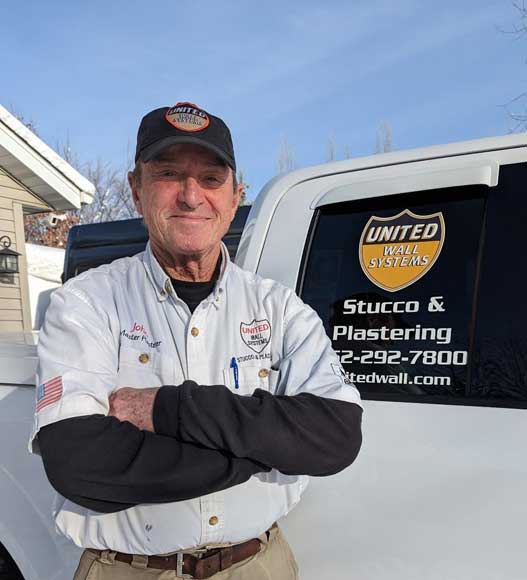 John Laudon standing next to the United Wall Systems restoration utility truck