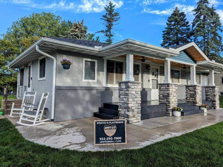 Home stucco restoration after image on a gray house