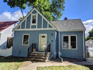 Outside view of a home after having blue stucco paint applied
