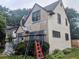 view of a home stucco repair project being performed