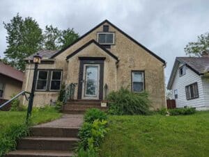 Curbside view of a home needing home stucco restoration services