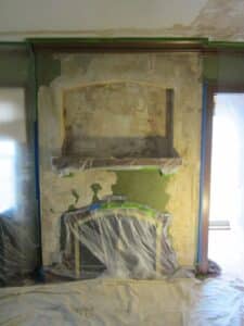 before image of fireplace plaster damage