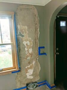 view of wall damage to plaster before repair